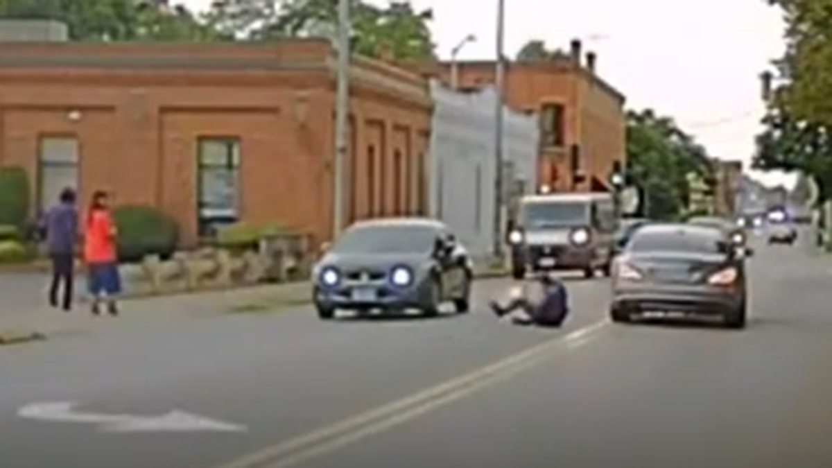 Massachusetts State Police Trooper slides along road after being dragged by vehicle