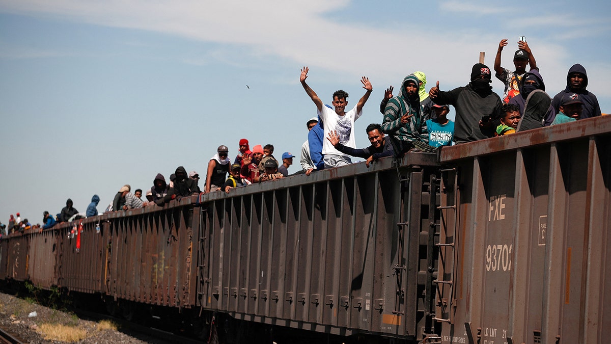 Asylum seekers heading to the U.S. travel aboard a train, in Paredon