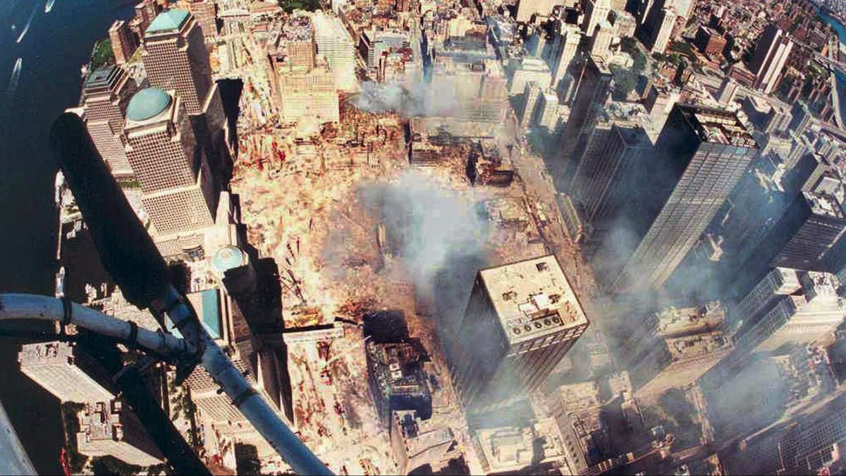 The wreckage of the World Trade Center smoulders in this aerial view of Manhattan taken September 15..