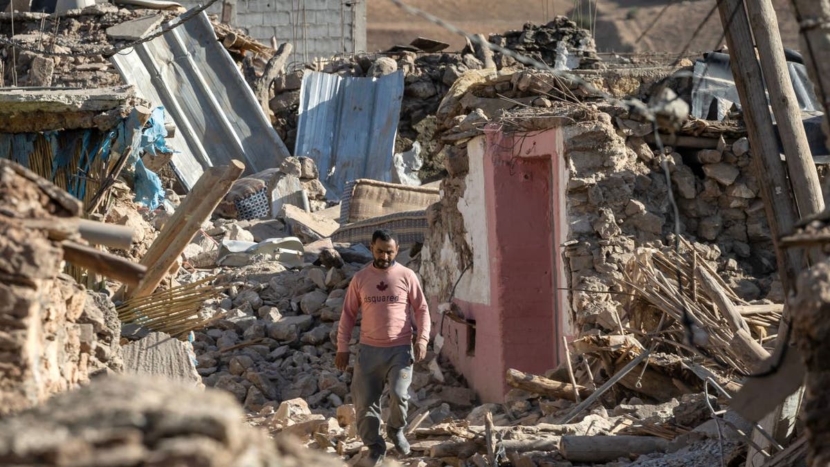Man walking near rubble in Morocco