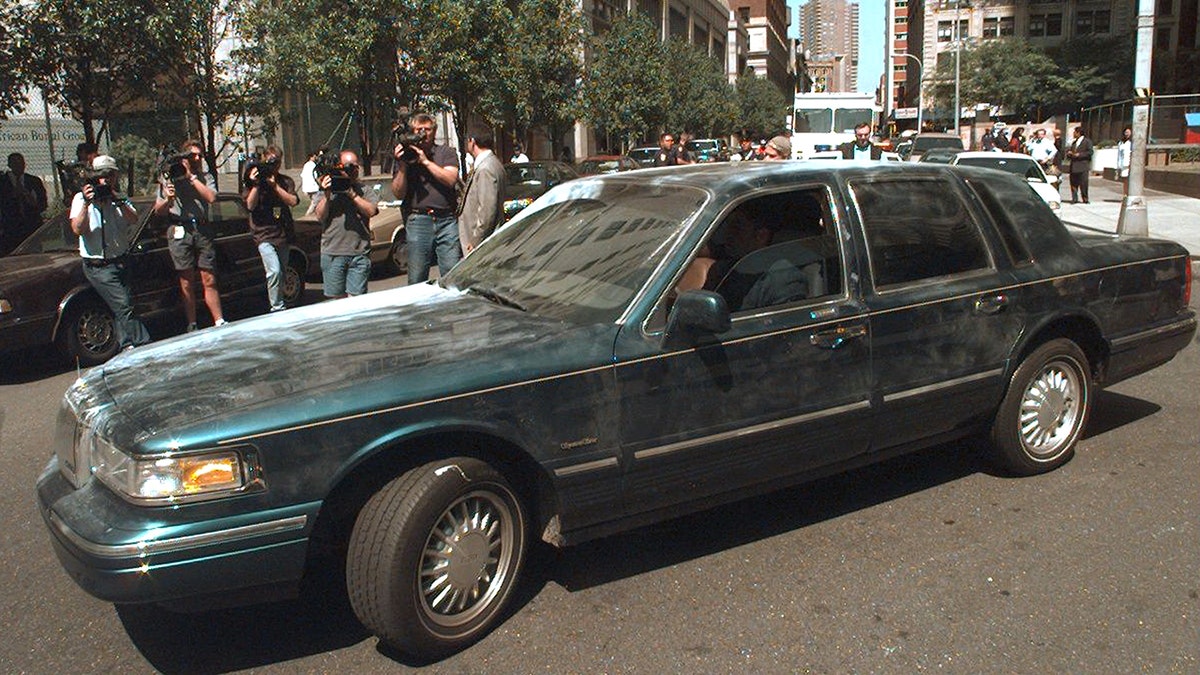 A close-up of a car surrounded by people
