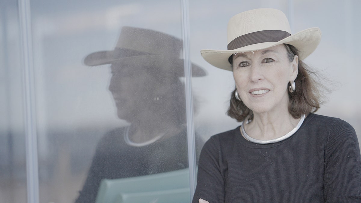 Clarissa Cici McNair wearing a black sweater and a straw hat
