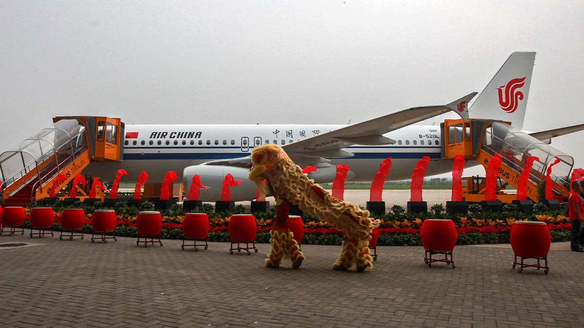 lion dance held outside an A320 plane