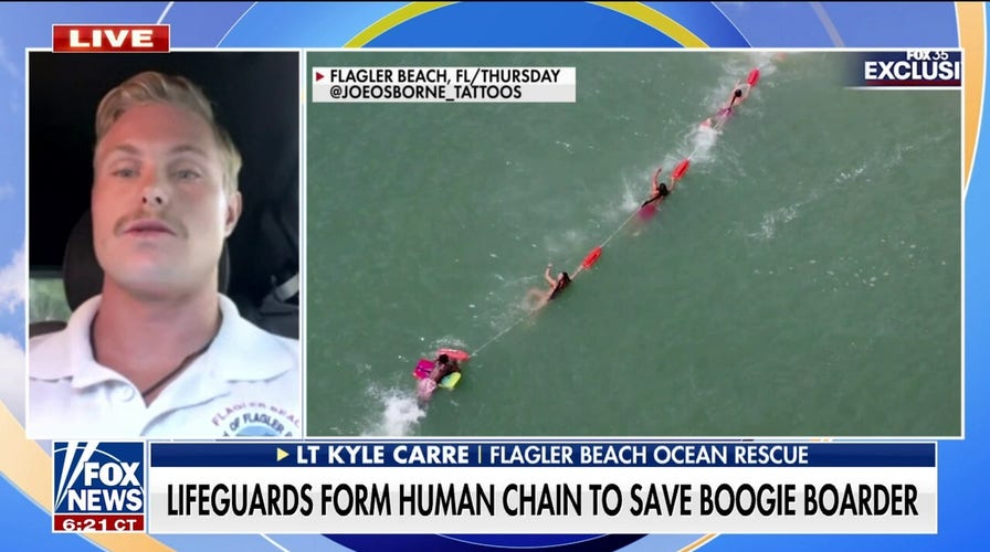 Florida lifeguards form human chain to save boogie border