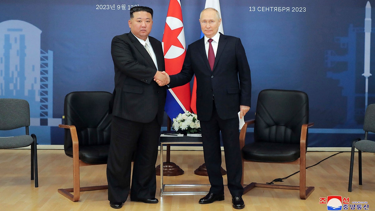 Jong Un and Putin shaking hands