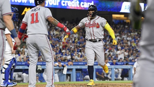 Atlanta Braves' Ronald Acuna Jr., right, celebrates with Orlando Arcia after hitting a grand slam as Los Angeles Dodgers catcher Will Smith watches during the second inning of a baseball game Thursday, Aug. 31, 2023, in Los Angeles. (AP Photo/Mark J. Terrill)