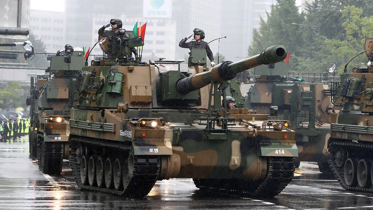A tank, South Korean military personnel