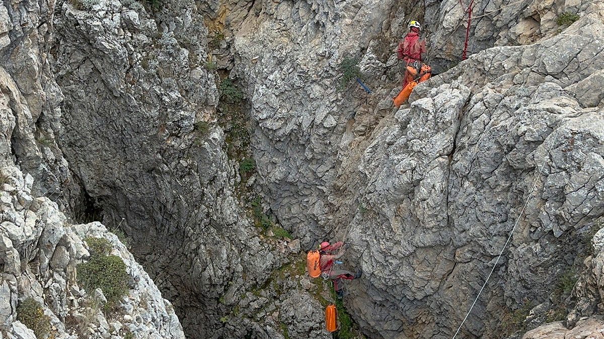 Climbers entering the cave