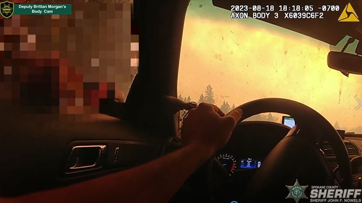 Spokane deputy drives through fire three