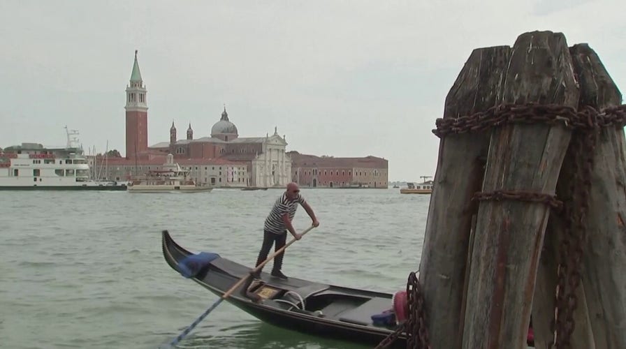 Tourists stroll the city of Venice amid travel surge