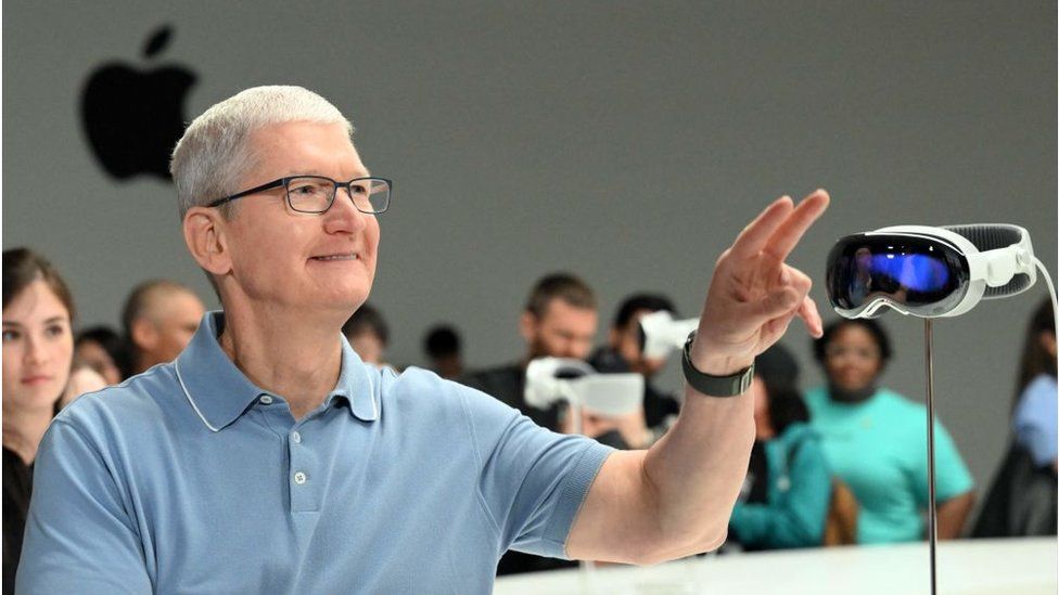 Apple boss Tim Cook beside the Vision Pro