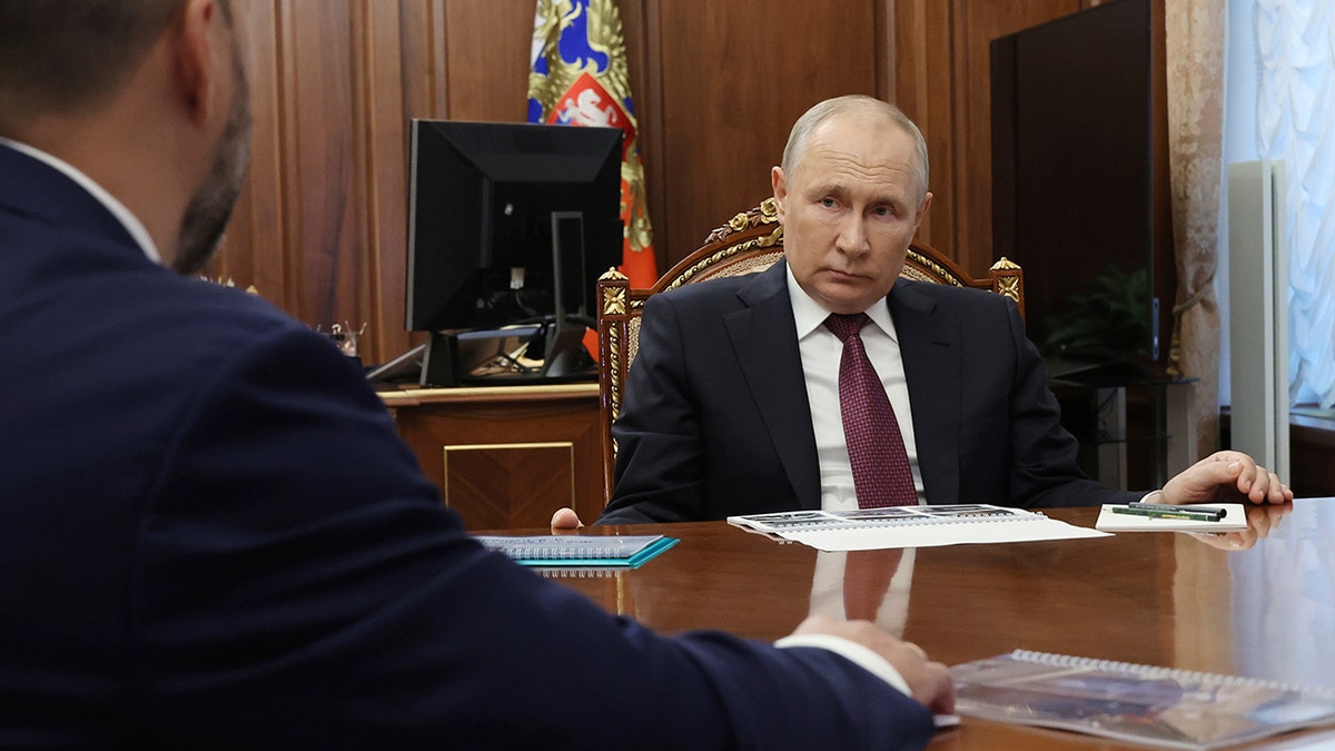 Putin at a desk