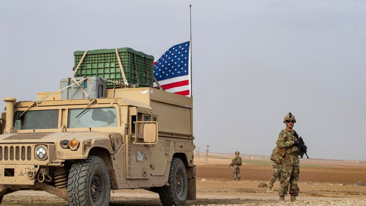 U.S. soldier in Syria by a humvee
