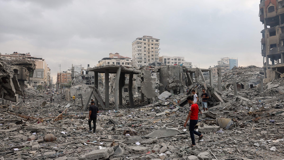 Palestinians look at damage from Israeli strike