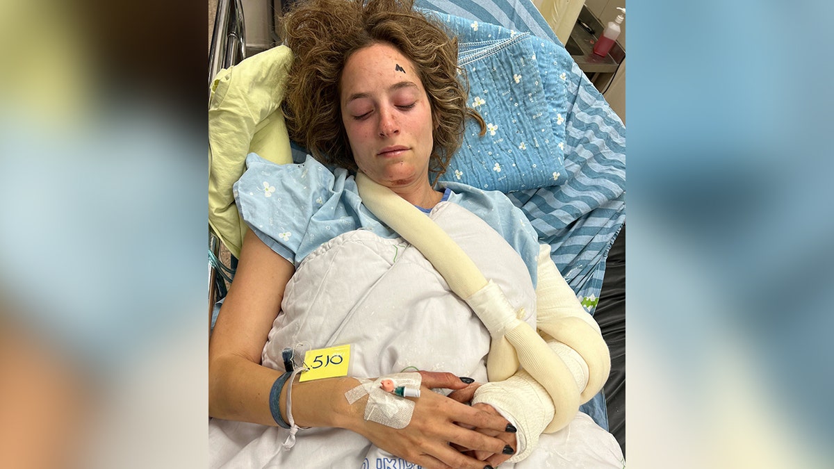 Noa Ben Artzi lying down in a hospital bed with eyes closed