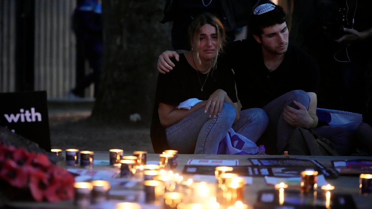 People who attend a vigil for Israeli victims