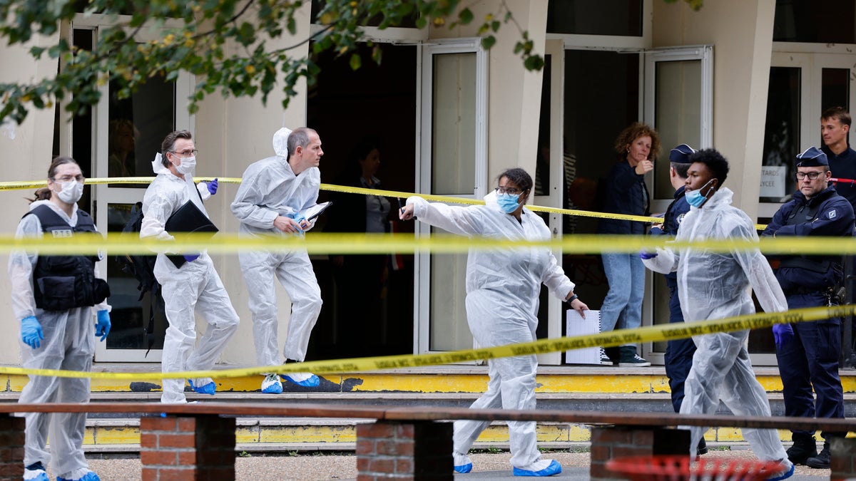 Forensic investigators in protective suits at the school crime scene