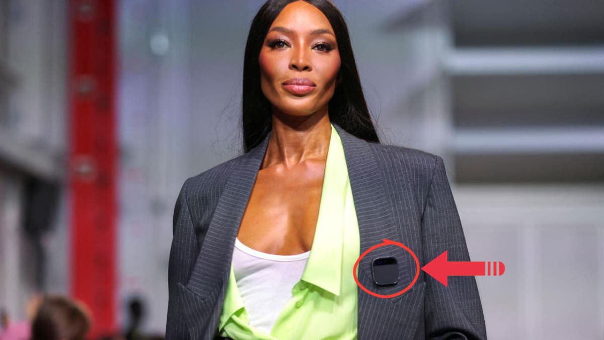 Naomi Campbell wearing a pin that uses AI.