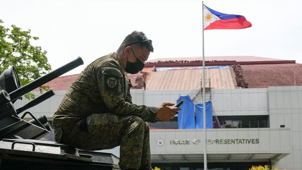 soldier uses smartphone