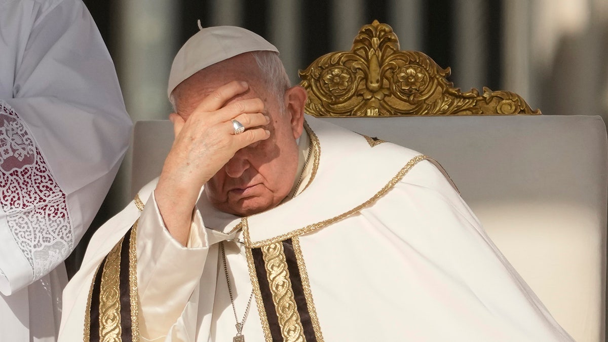 Pope Francis shades his eyes from the sun at the Vatican