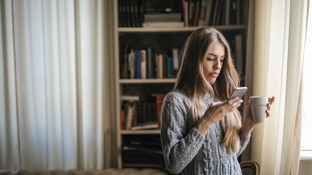 woman looking at her phone