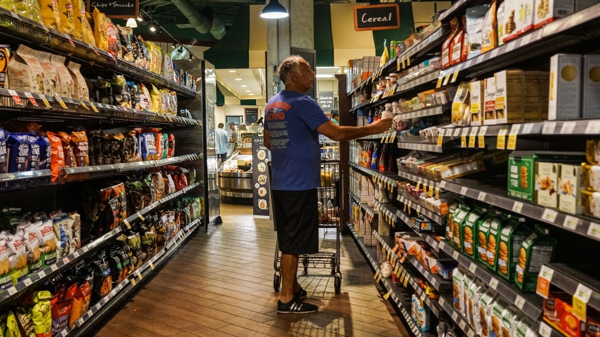 A senior man shops at a supermarket