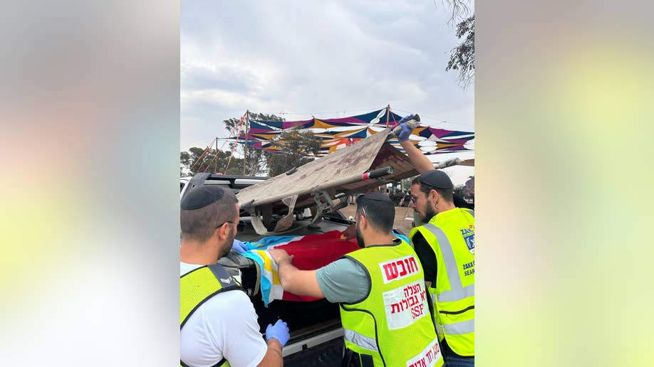 ZAKA loads stretchers into truck for body recovery
