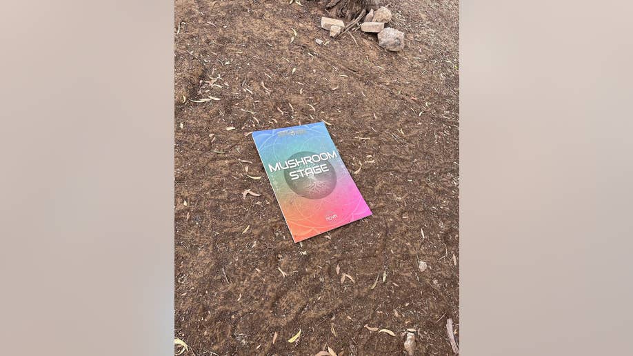 Flyer of "Mushroom Stage" lays on floor at festival after massacre of attendees by Hamas