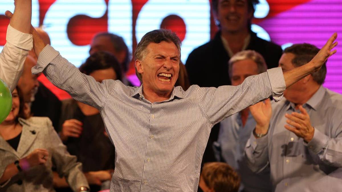 Surrounded by supporters, the current Mayor of Buenos Aires and presidential candidate Mauricio Macri celebrates at the end of mayoral elections in Buenos Aires, Argentina, Sunday, July 5, 2015. Buenos Aires will have a runoff election that would have the current Cabinet Chief of Buenos Aires and mayoral candidate Horacio Rodriguez Larreta competing against Martín Lousteau, candidate of the ECO coalition. (AP Photo/Daniel Jayo)