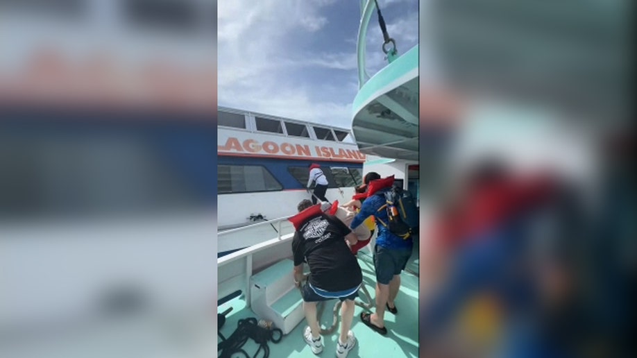 Passengers try to aid others Blue Lagoon Island