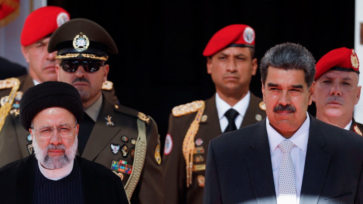 Venezuelan President Nicolas Maduro, right, meets with Iranian President Ebrahim Raisi 