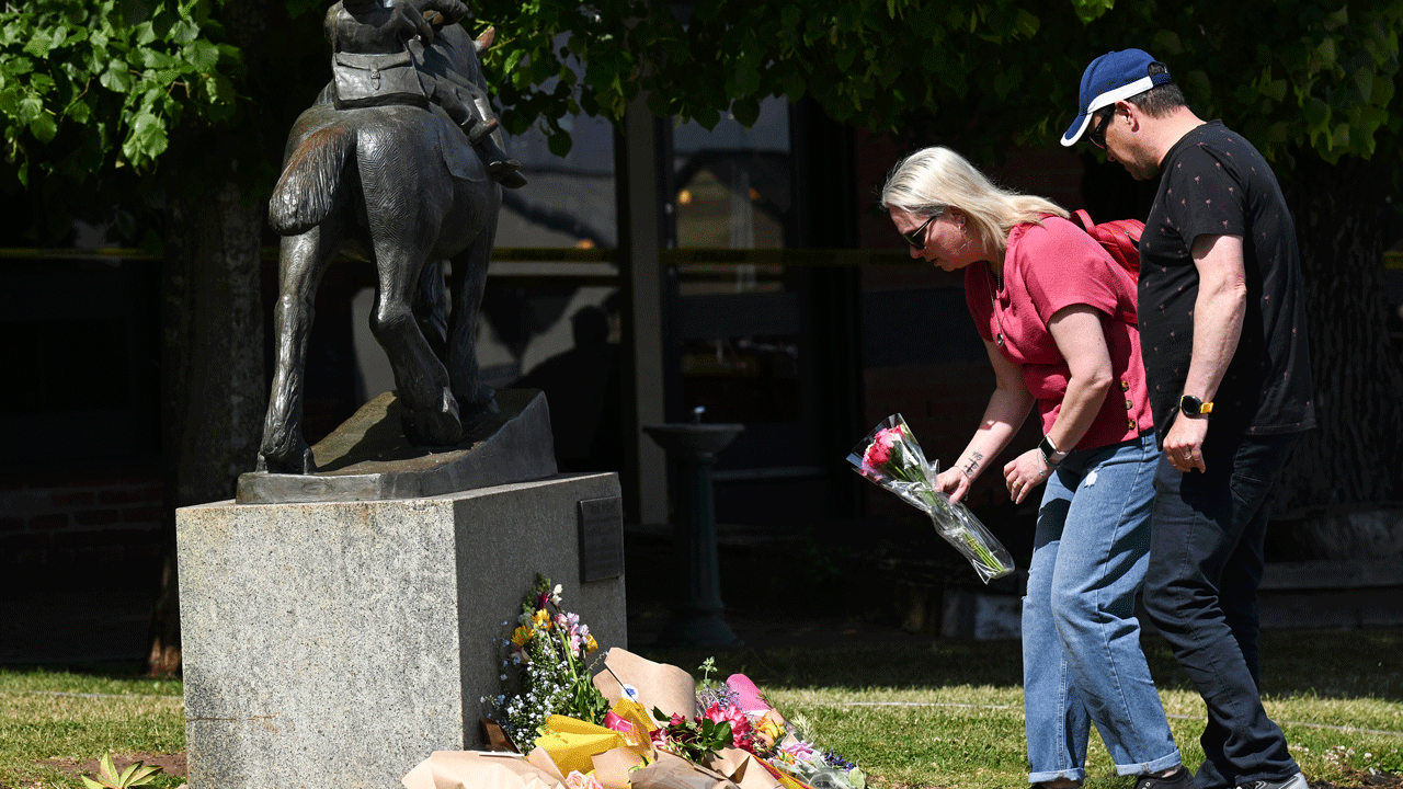 Mourners gather at site of fatal crash outside Melbourne pub.