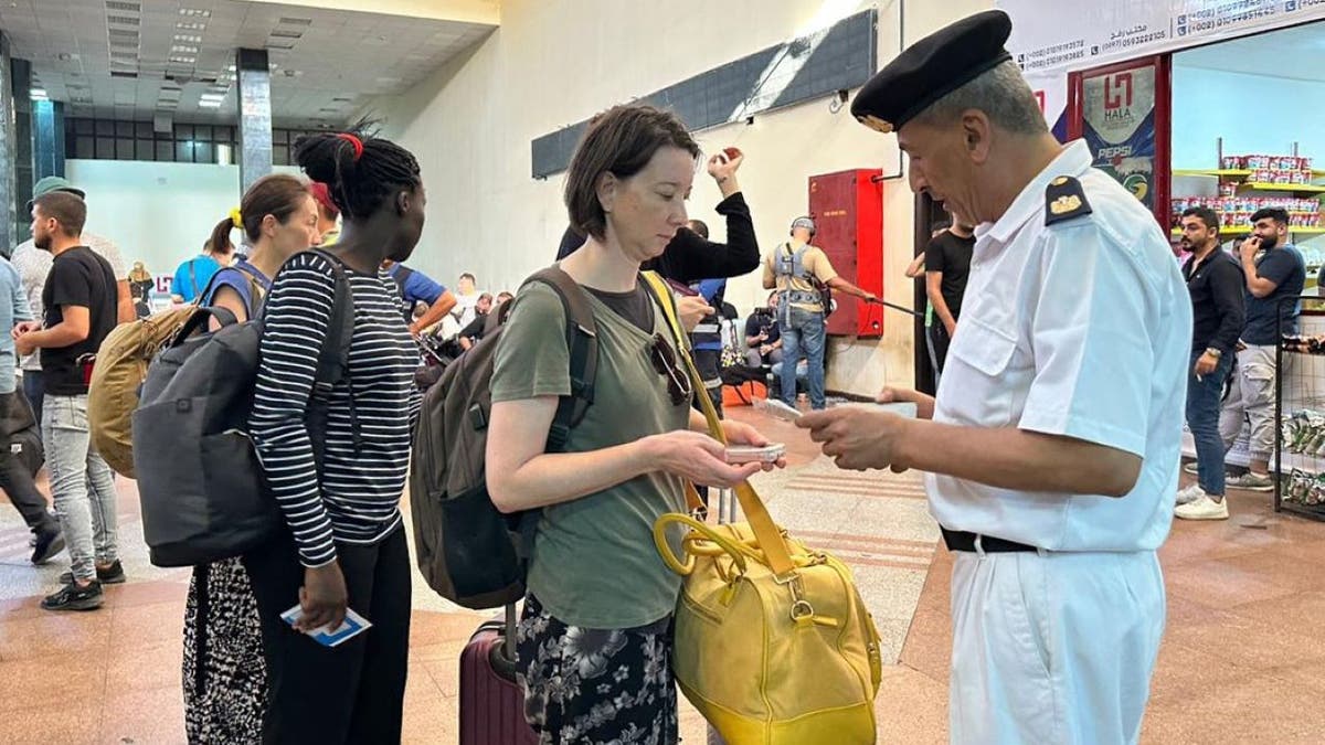 Woman showing official her passport