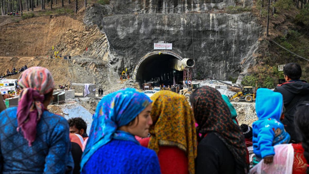 Villagers and locals outside the India tunnel where men are trapped