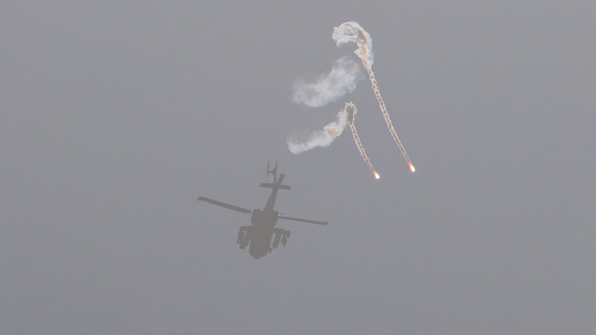 A helicopter, flares