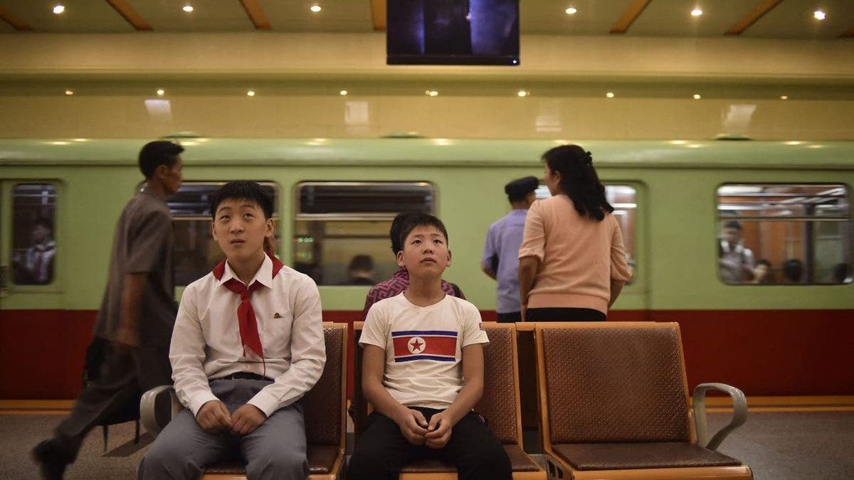 North Korea school kids in train station