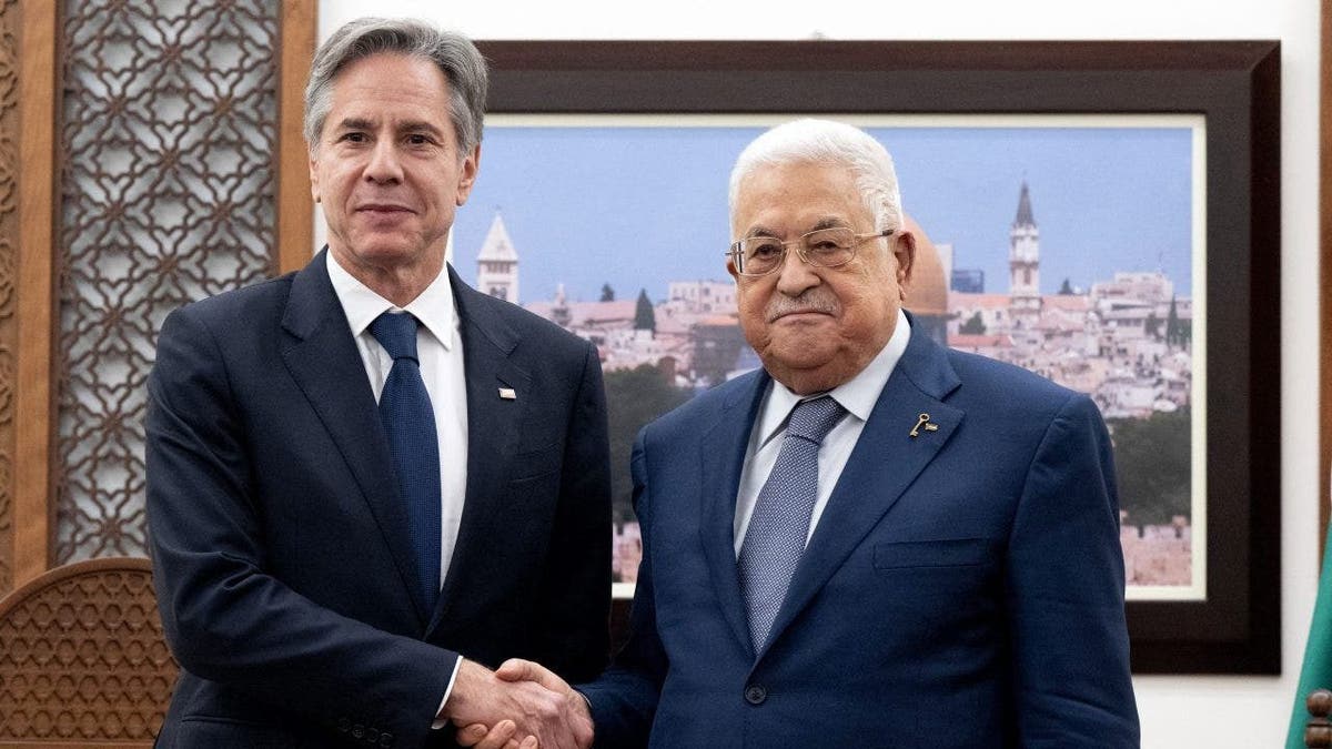 Abbas shaking hands with Blinken