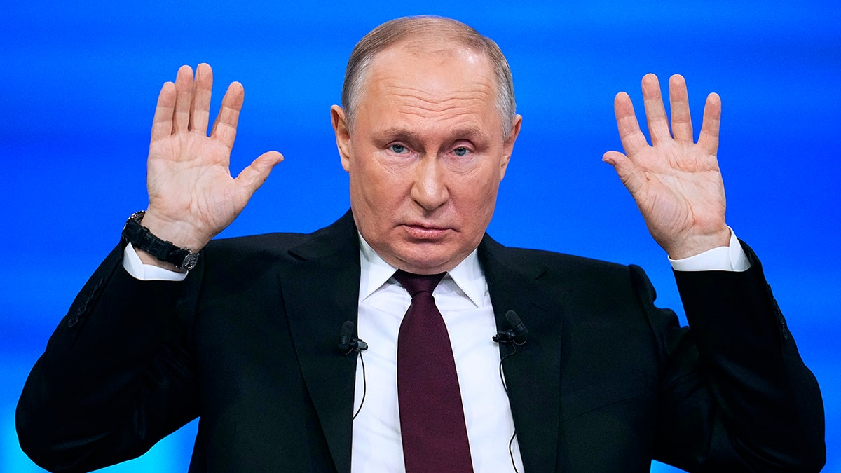 Putin with his hands raised