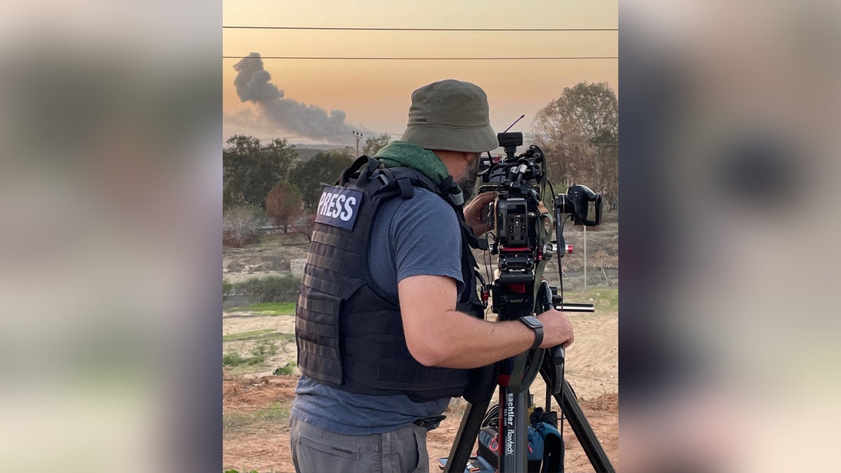Cameraman filming Gaza strikes.