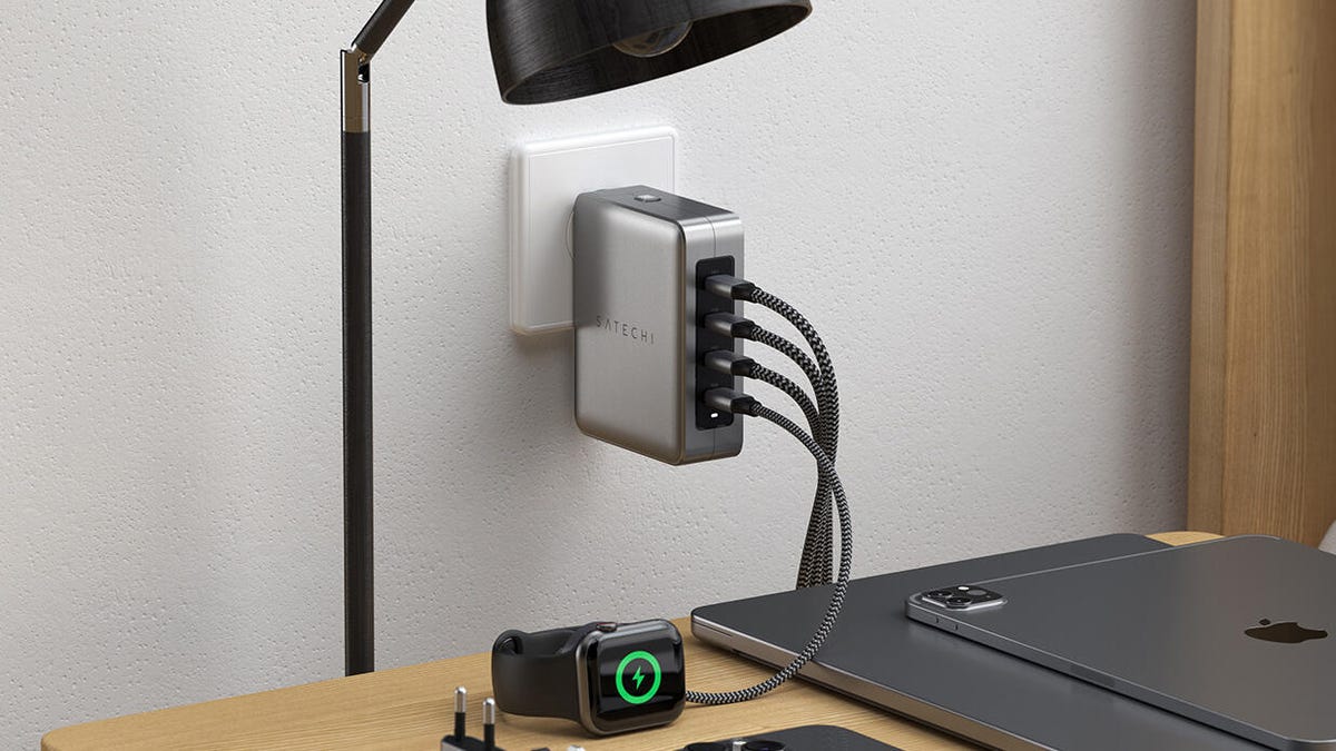 Satechi's 145W 4-port USB-C travel charger plugged into a wall with 4 cables protruding