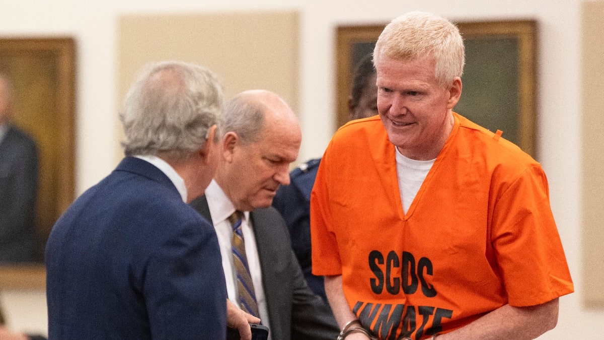 Alex Murdaugh talks with his attorneys Dick Harpootlian, left, and Jim Griffin during his sentencing for stealing from 18 clients, Tuesday, Nov. 28, 2023, at the Beaufort County Courthouse in Beaufort, S.C.