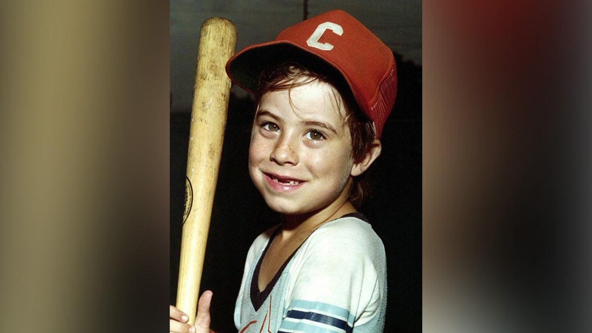 Adam Walsh holding a baseball bat