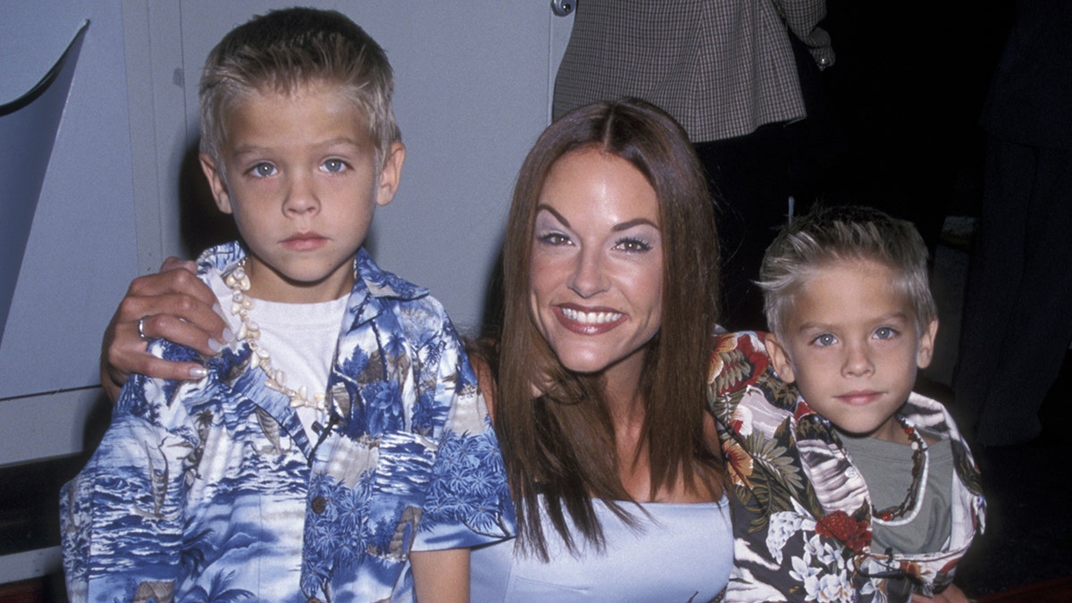 Dylan and Cole Sprouse with their mom on the red carpet
