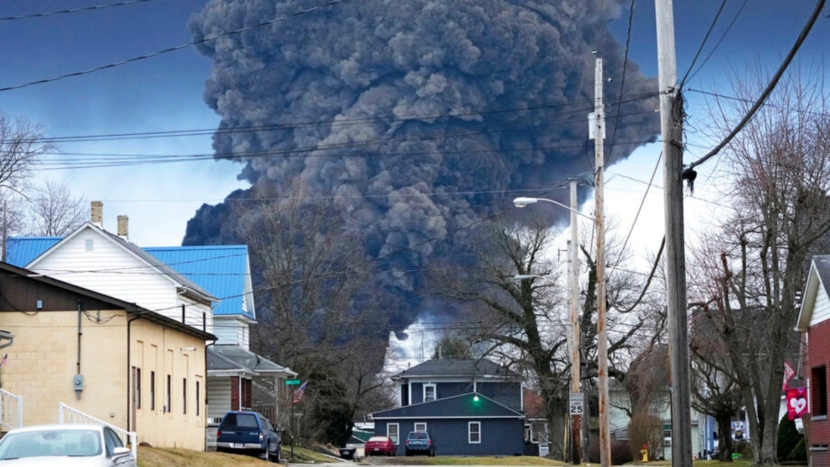 A large plume of smoke rises over East Palestine, Ohio