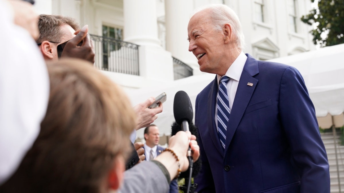 President Joe Biden speaks with members of the media