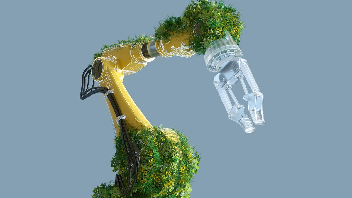 A bright yellow robot arm is covered in mossy greenery. Get it? Tech can be sustainable!