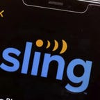 A cellphone displays the Sling TV logo.