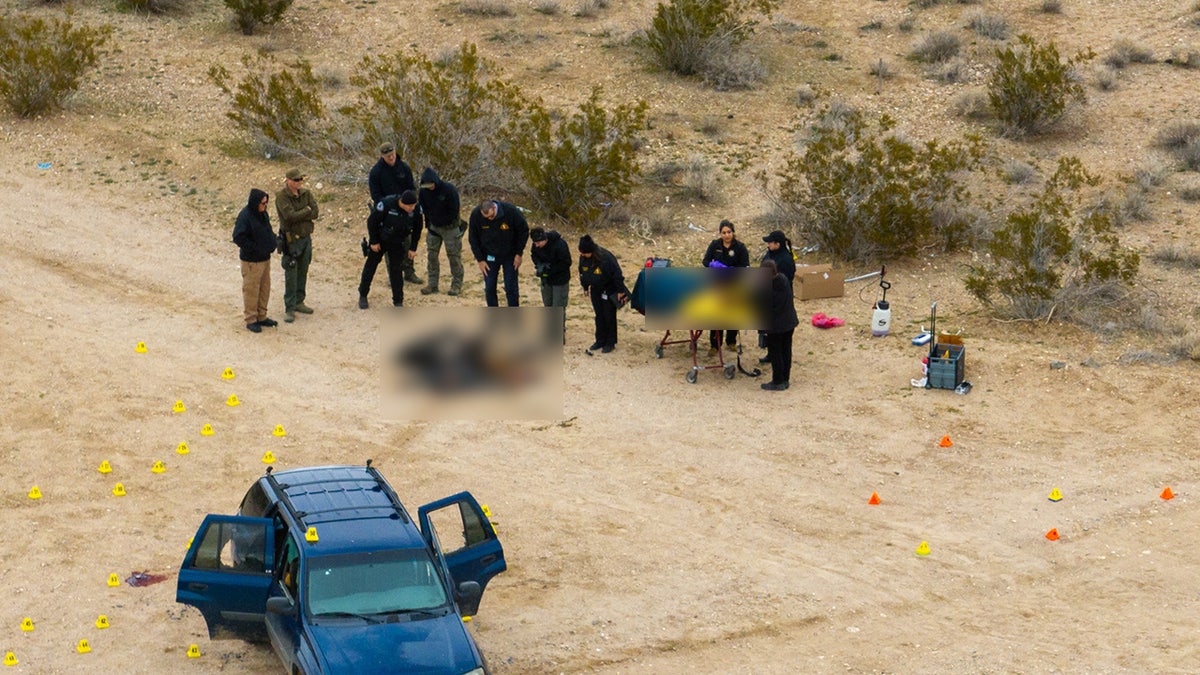 San Bernardino sheriff's department officials investigate scene where five were found dead in a remote area of San Bernardino county