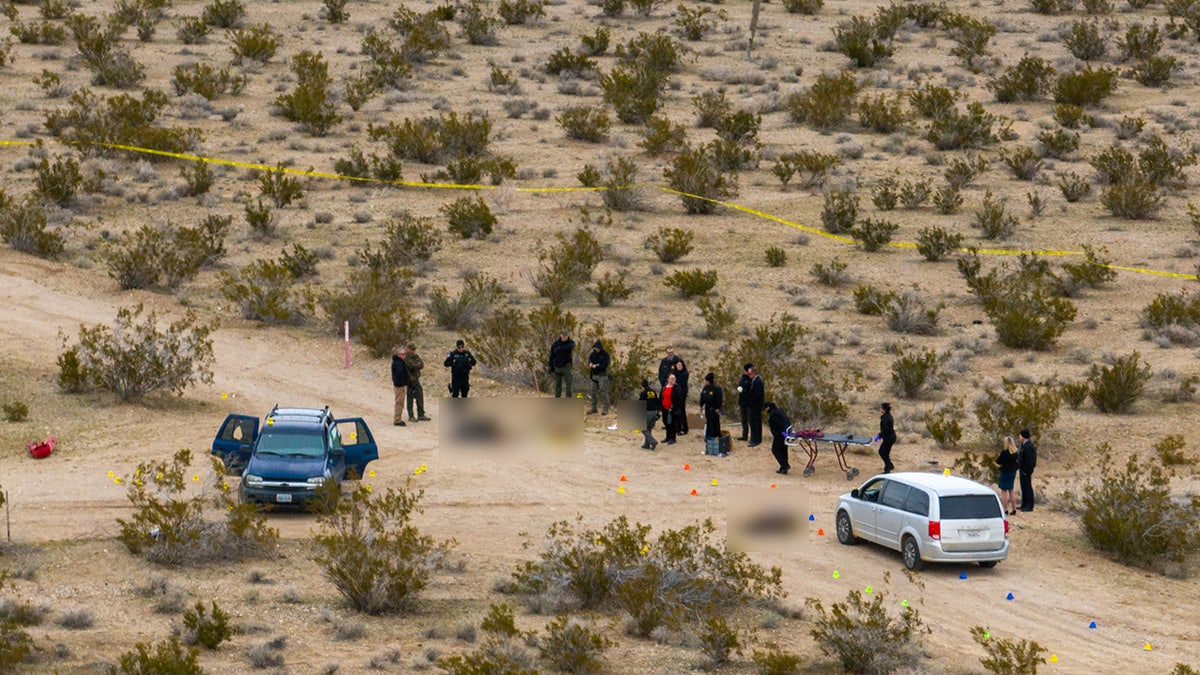 San Bernardino sheriff's department officials investigate scene where five were found dead in a remote area of San Bernardino county