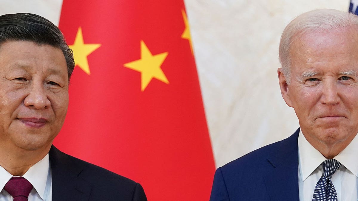 BidenBiden and Xi stand in front of the Chinese and US flags